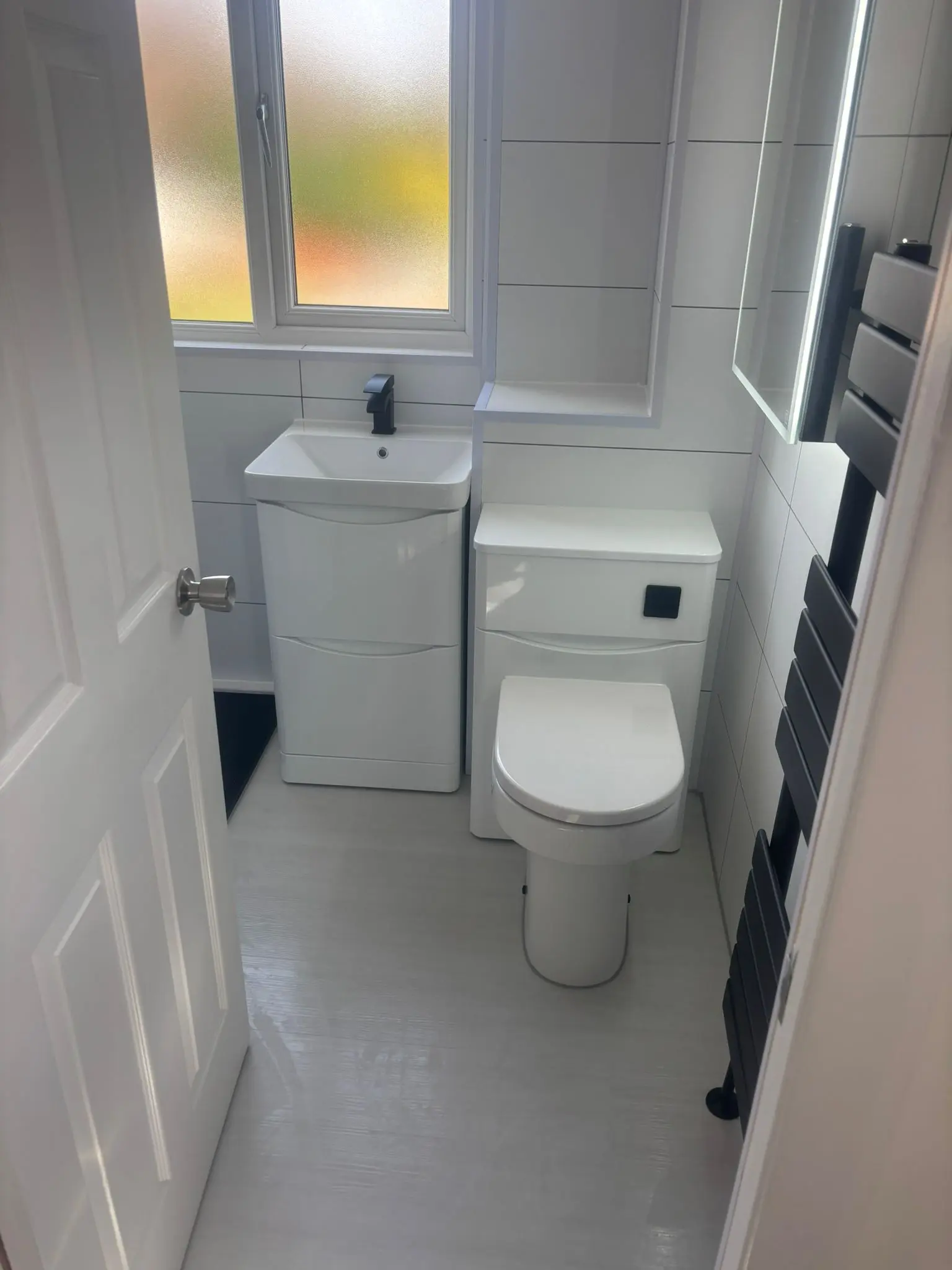 Completed bath-to-shower conversion in Portobello with Crittall shower screen and matte black fixtures