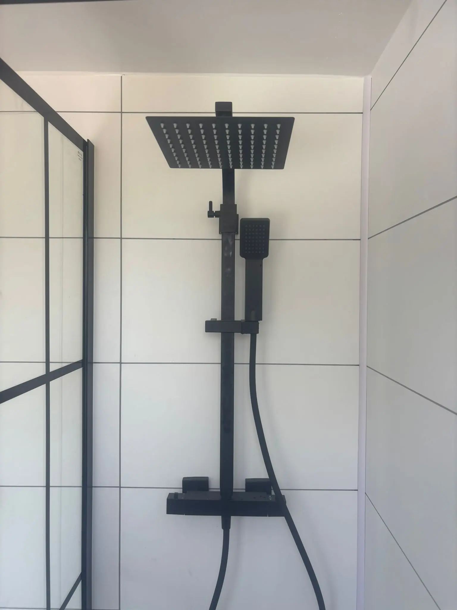Matte black rainfall shower head professionally fitted by Edinburgh bathroom fitters