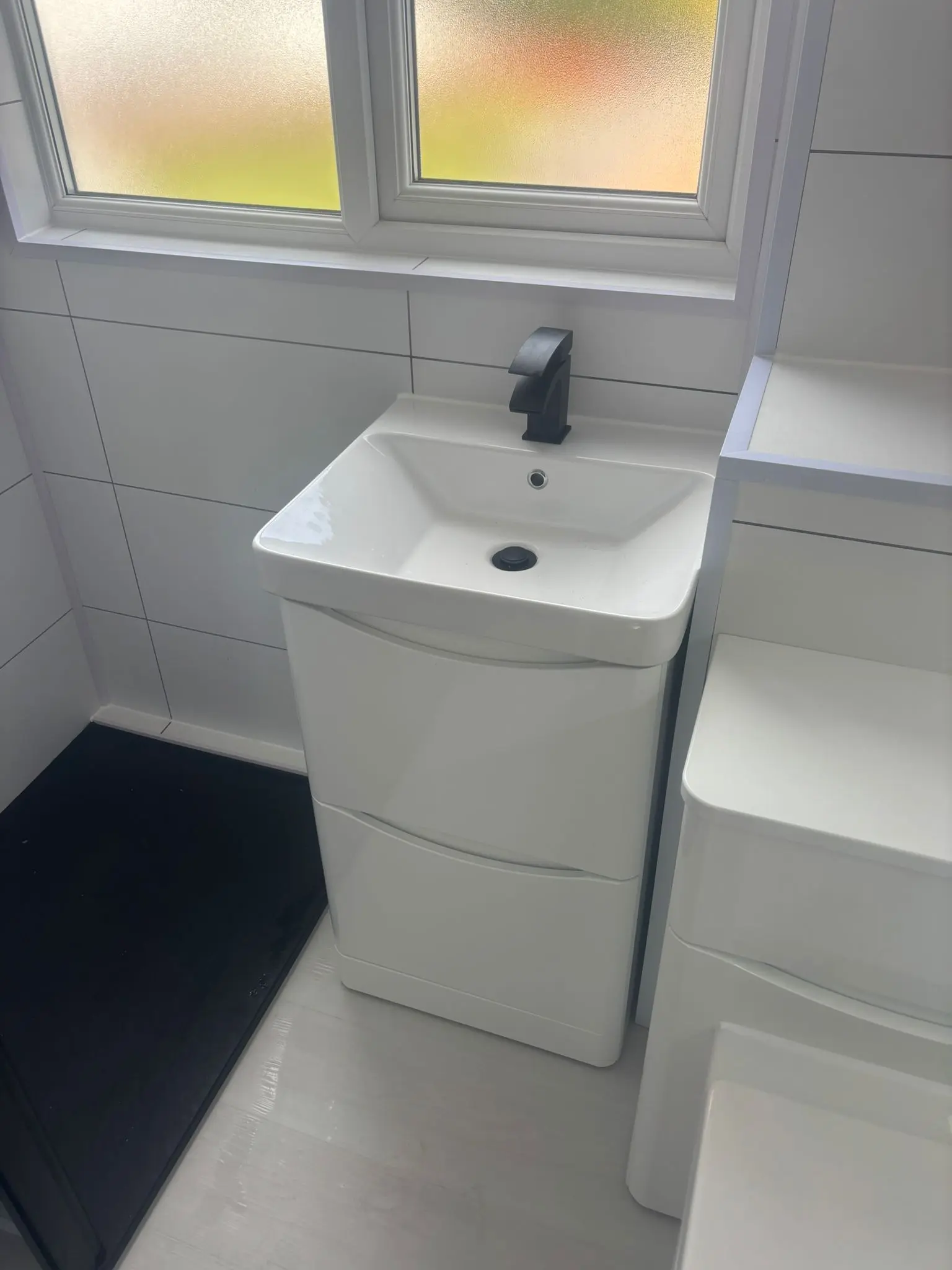 Curved vanity unit with matte black tap fitted by Edinburgh bathroom fitters
