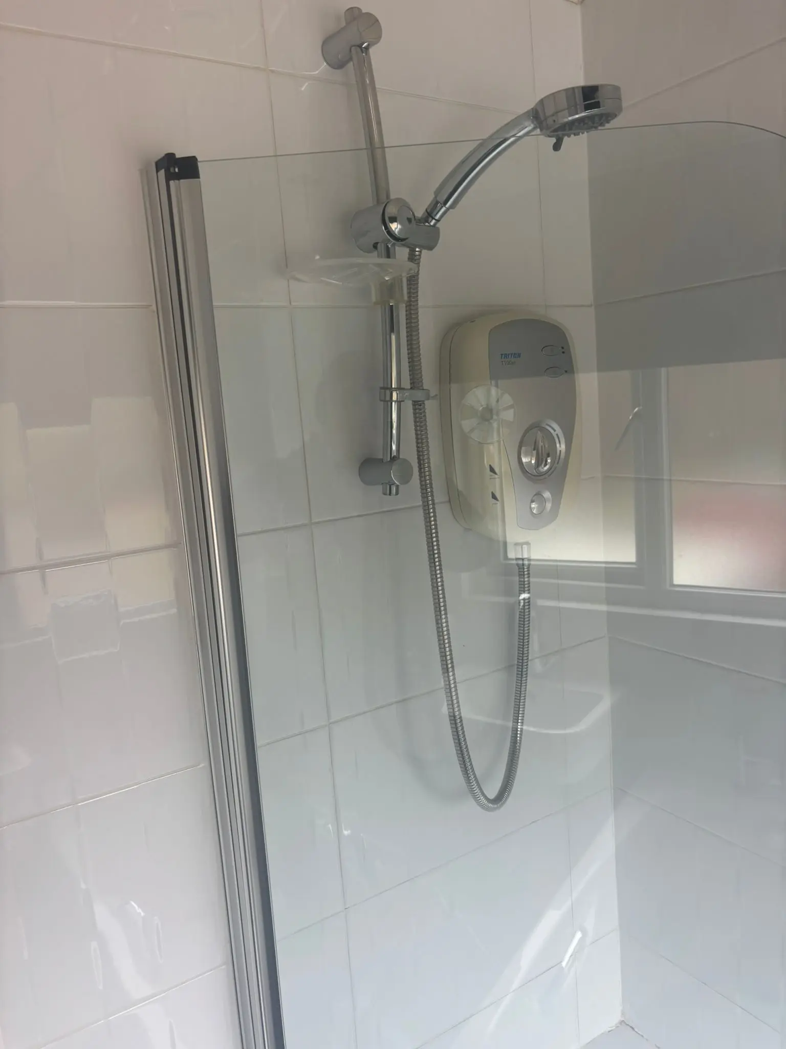 Old electric Triton shower over bath before replacement in Portobello