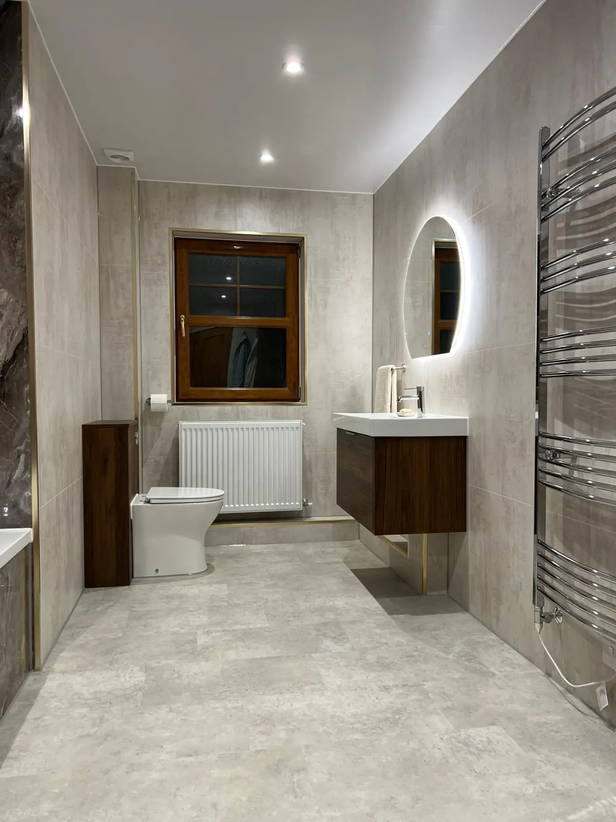 Bathroom with oval LED mirror and walnut vanity unit